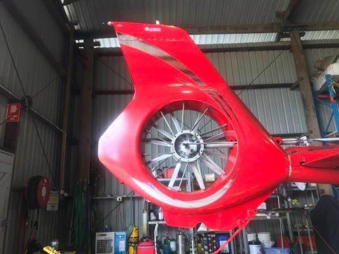 A Red Helicopter Is Sitting In A Hangar — Cairns Signcorp In Portsmith, QLD