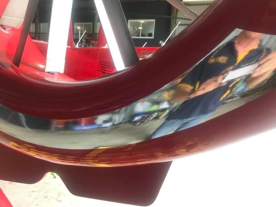 A Man In A Blue Shirt Is Reflected In A Helicopter Wheel — Cairns Signcorp In Portsmith, QLD