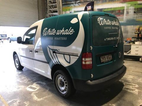 A White Whale Van Is Parked In A Garage — Cairns Signcorp In Portsmith, QLD