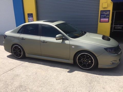 A Car Is Parked In Front Of A Garage Door — Cairns Signcorp In Portsmith, QLD