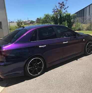 A Purple Car Is Parked On The Side Of The Road — Cairns Signcorp In Portsmith, QLD