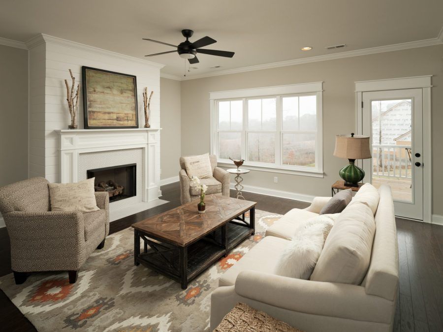 A living room with a couch , chairs , coffee table and fireplace.