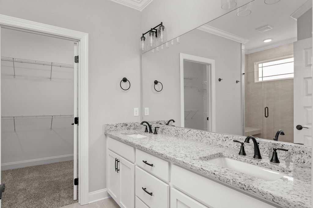 A bathroom with two sinks and a large mirror.