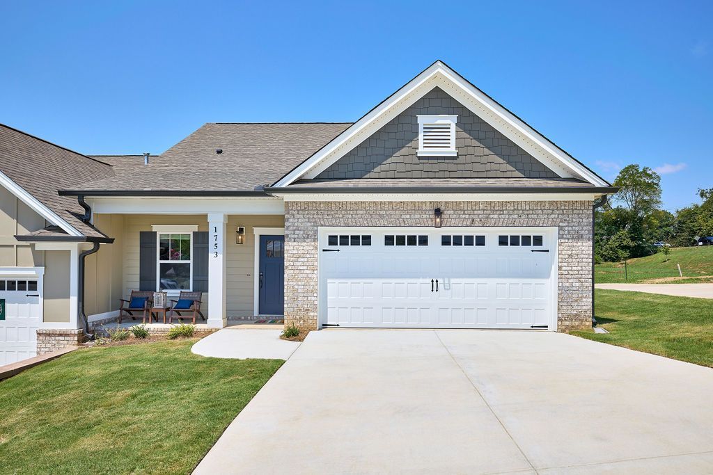 The front of a house with a white garage door and a blue door.