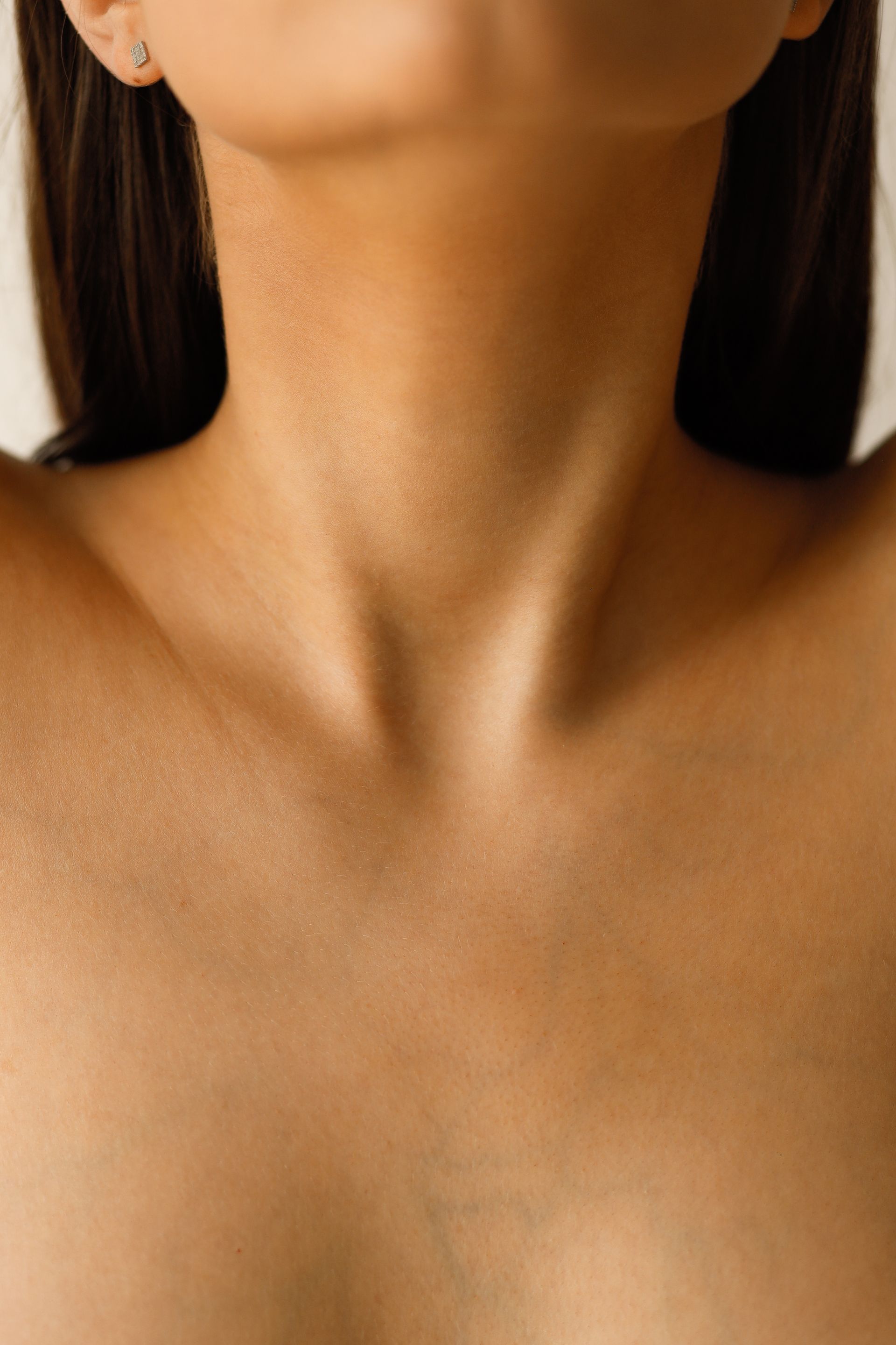 A close up of a woman 's neck and chest.