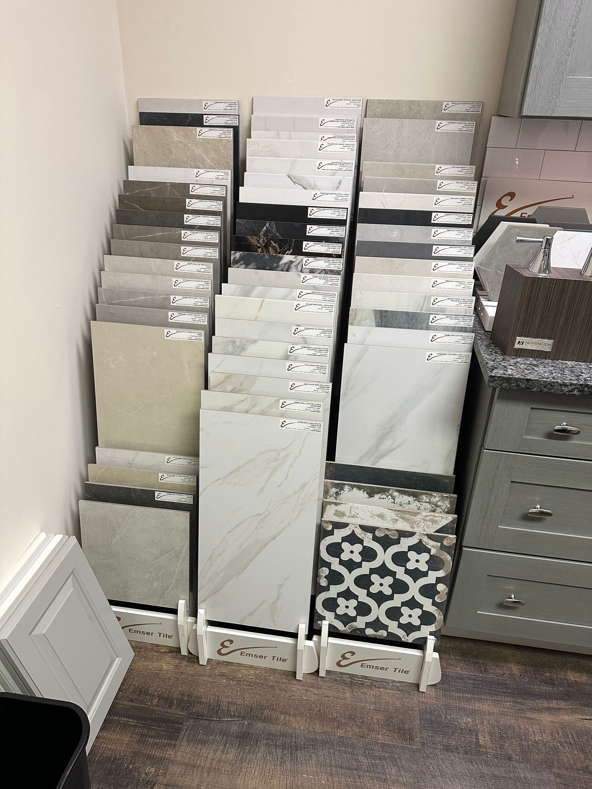 Tile samples on display in a store, showcasing various colors and patterns.