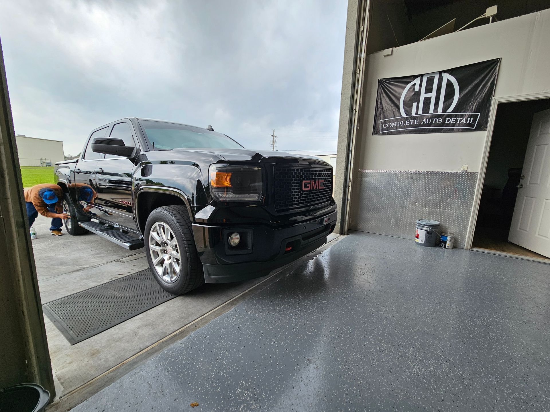 Ceramic coating being buffed into a car's paint.