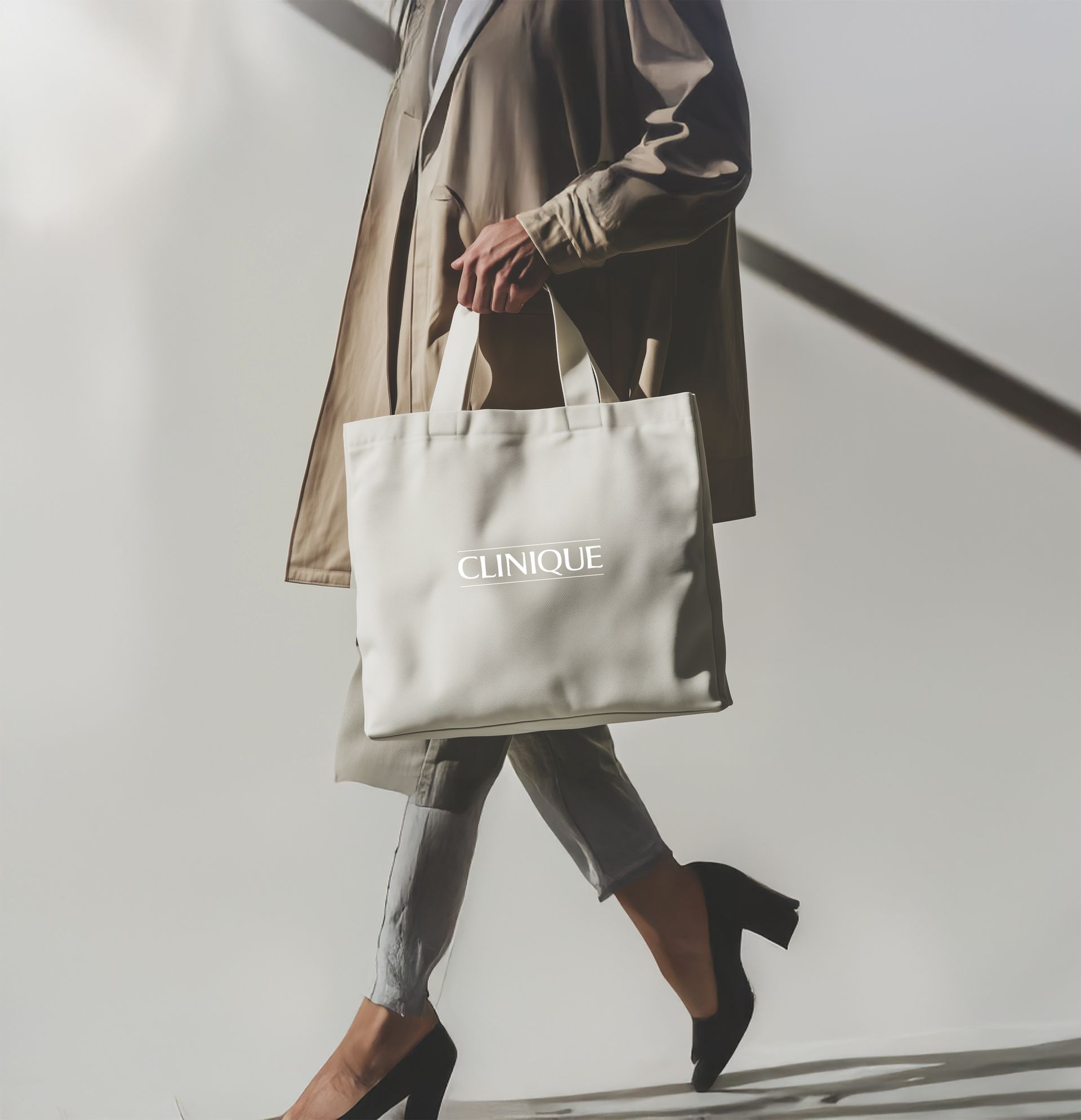 A woman is carrying a white clinique tote bag