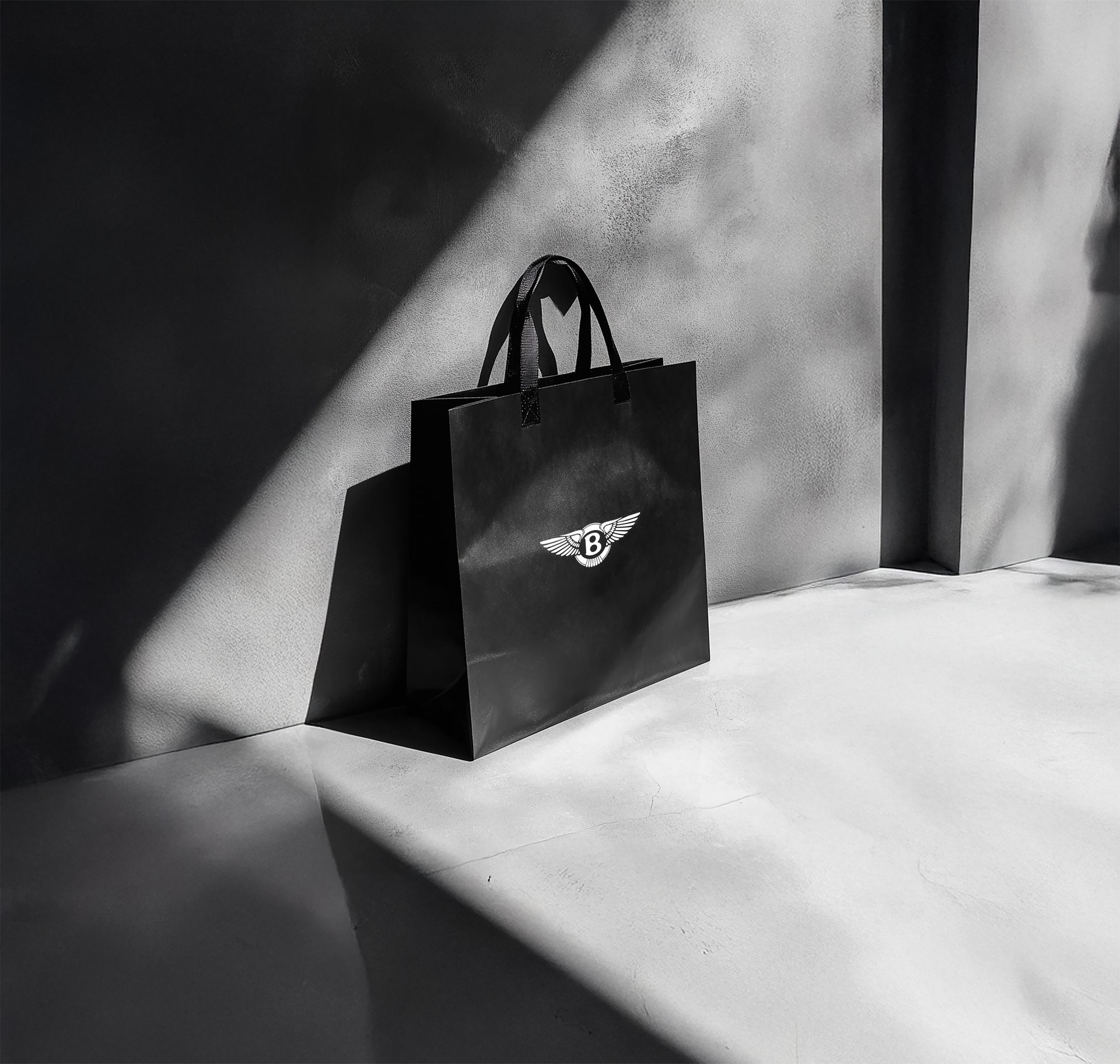 A black and white photo of a black shopping bag