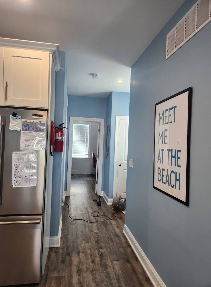 A hallway with light blue walls, a