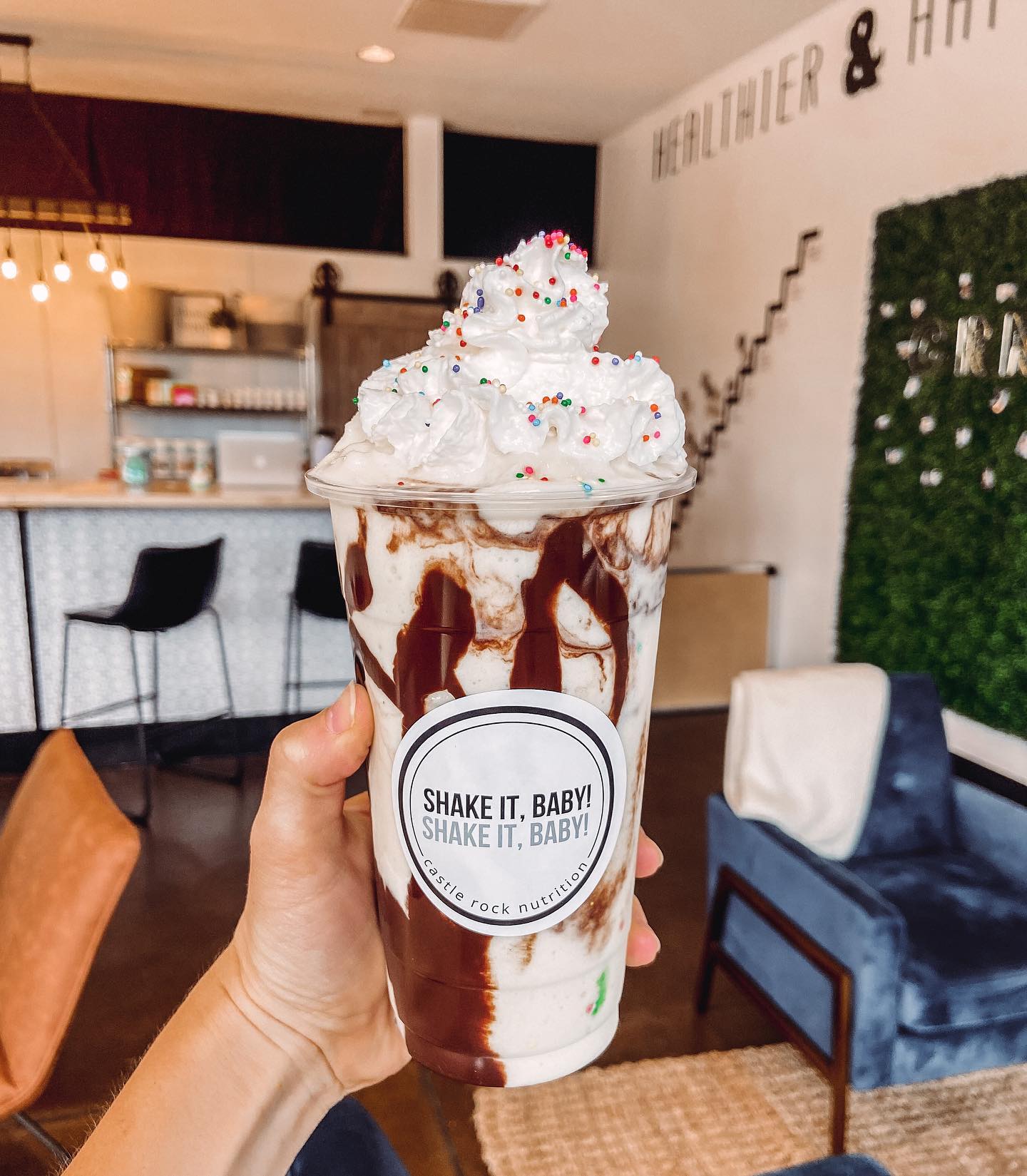 A person is holding a shake that says shake it baby on it