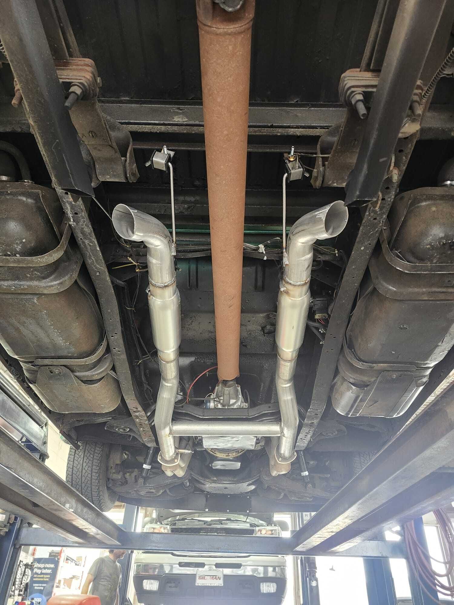 Underneath view of a vehicle showing exhaust pipes and other components.| Garbs Automotive & Exhaust