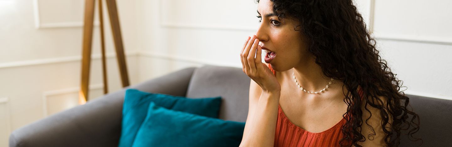 Seattle woman smelling her bad breath