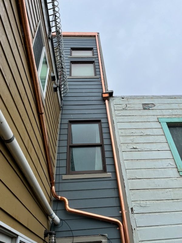 A close up of a gutter on a roof of a building.