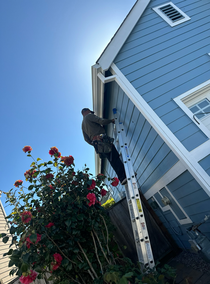 A close up of a gutter on the side of a house