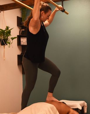 Kim performing Ashiatsu massage - stretching the back
