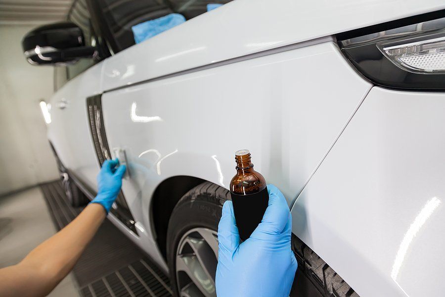 Worker restoring car paint