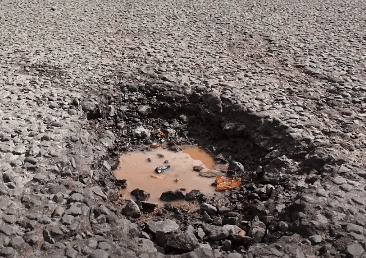 The first image is of a large, deep pothole in asphalt. The second image is of an extremely deep crack in asphalt with the sub base exposed.