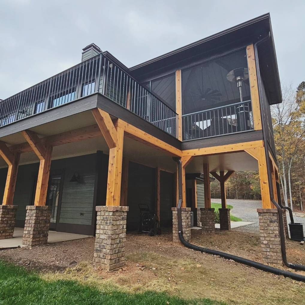 A large house with a screened in porch and a balcony