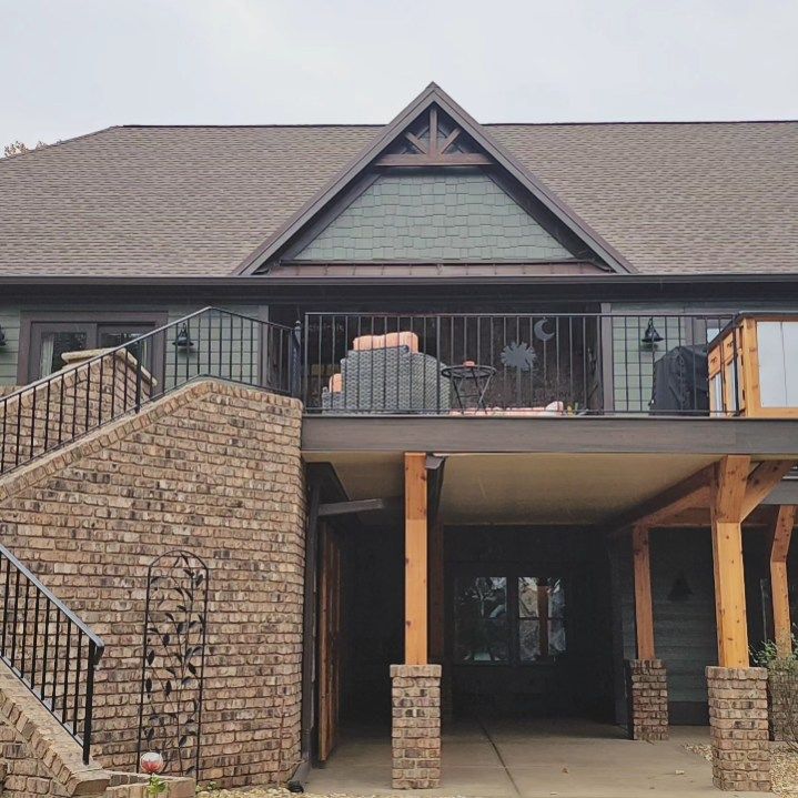 A large brick house with a balcony and stairs