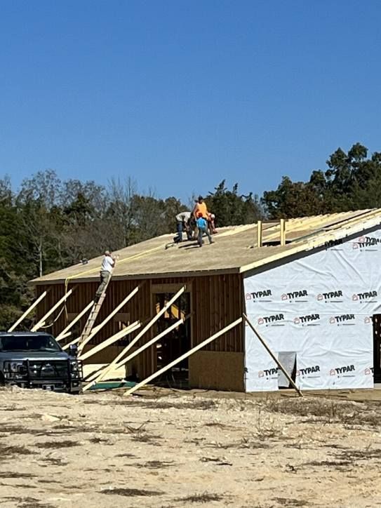 A group of people are working on the roof of a building.