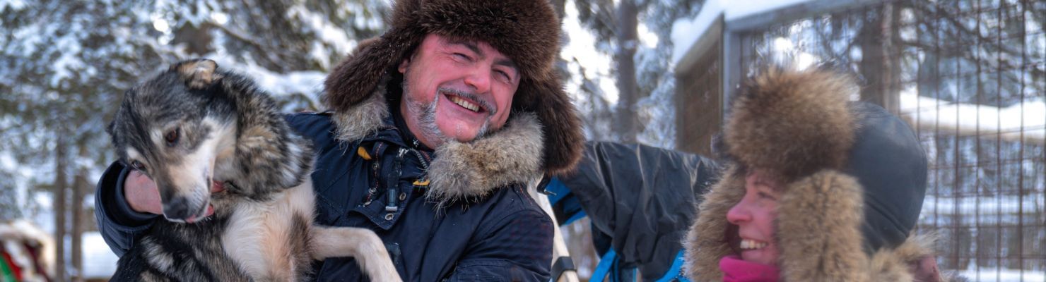 Cuddling with husky dogs