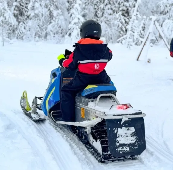 Child riding own snowmobile