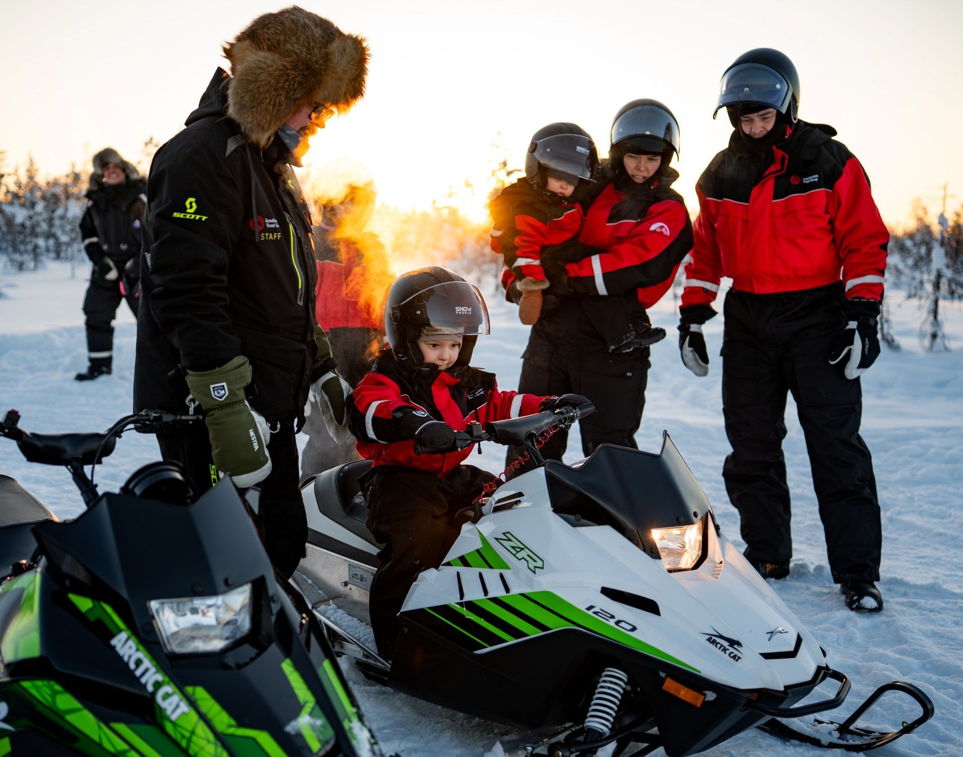 Small children snowmobile driving