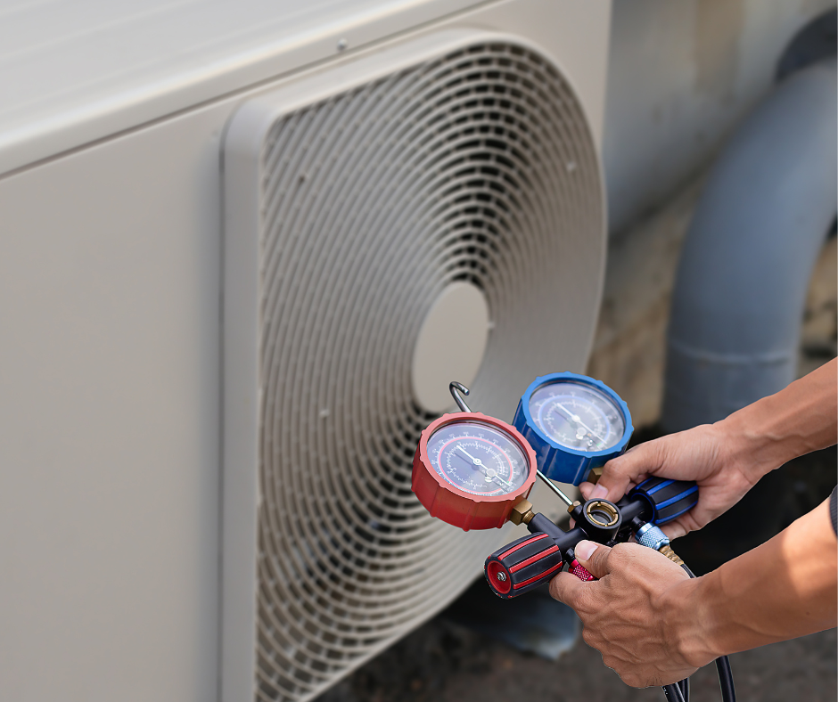 HVAC technician checking system pressure during routine HVAC maintenance service
