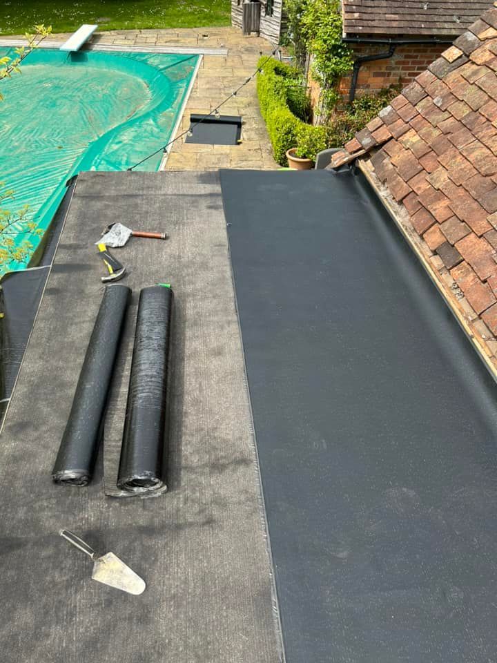 A roof with flat felt roofing supplies on it.