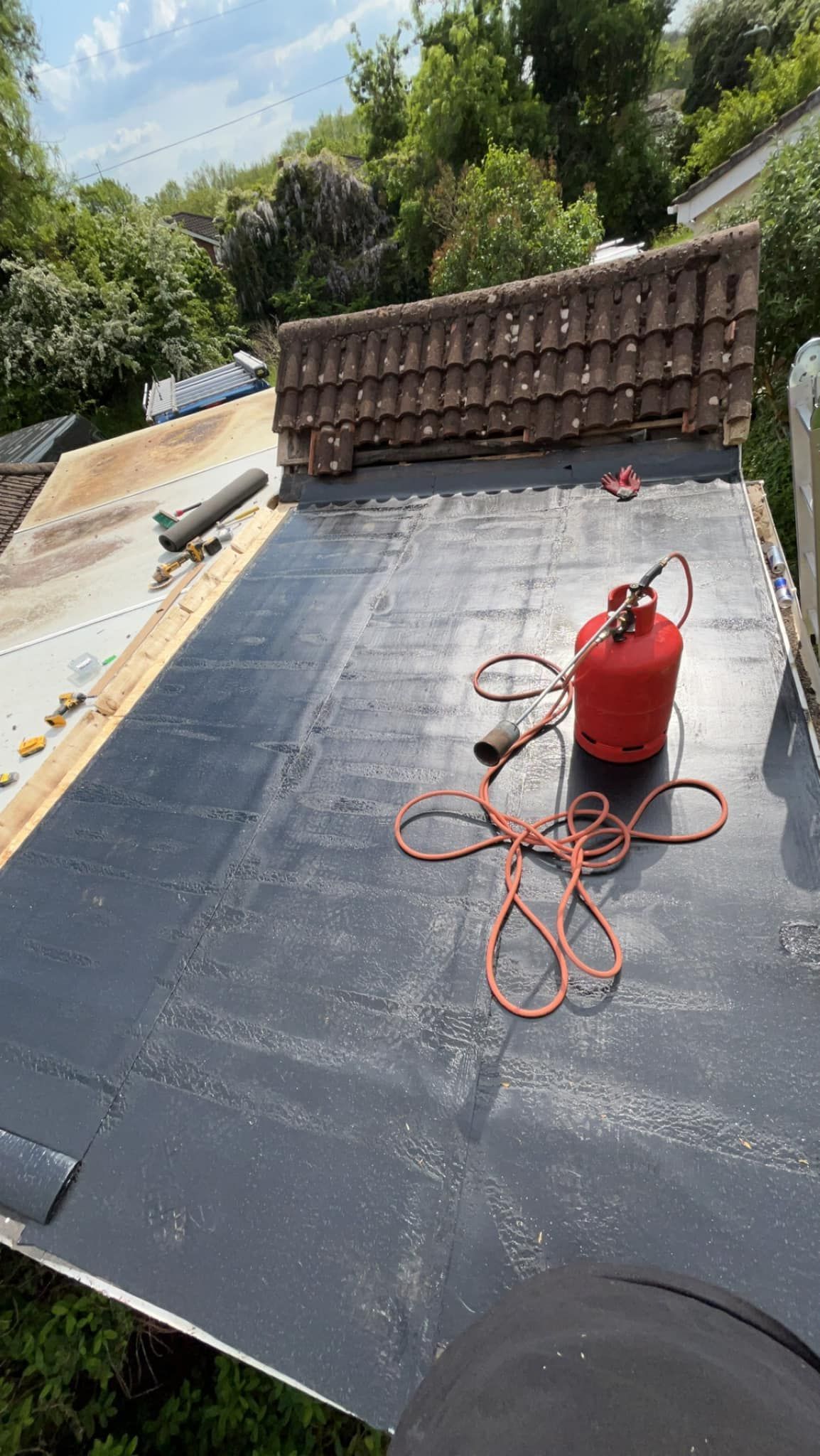 A flat roof with heat tools for installation of the new roof materials
