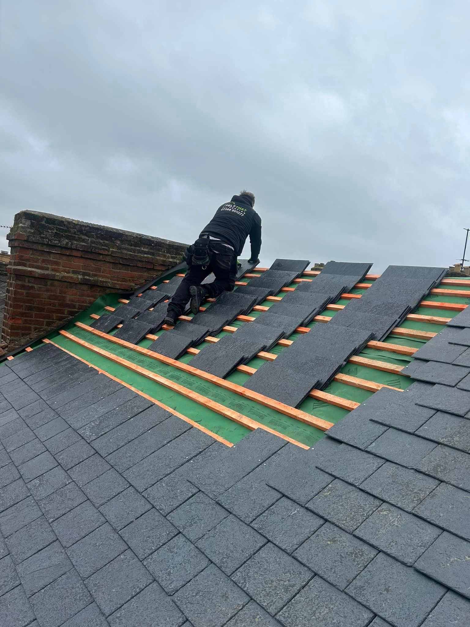 A man is working on the roof of a building.