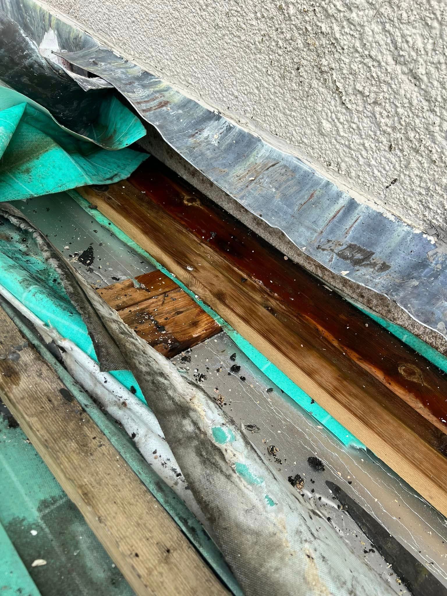 A close up of a piece of wood and metal on a roof.