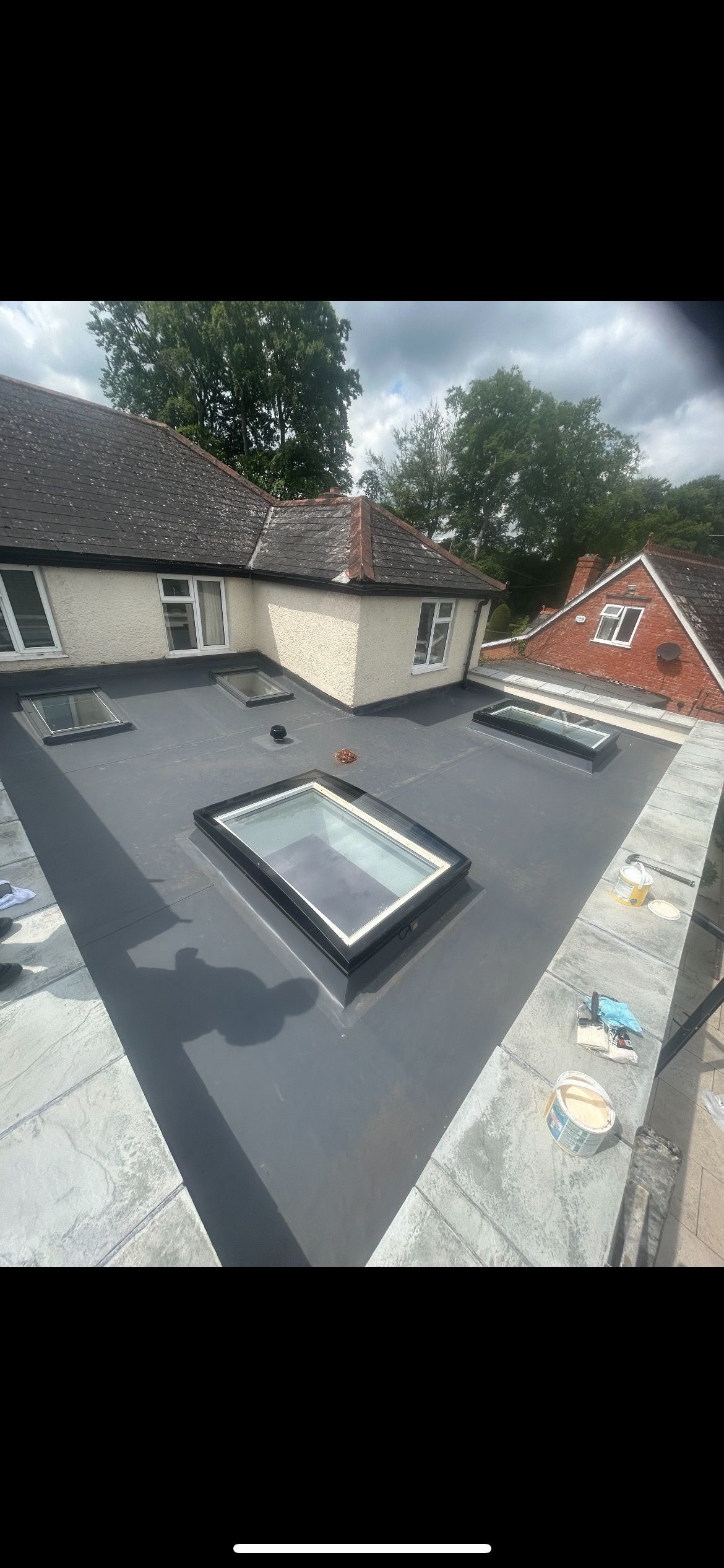 There are two skylights on the roof of a house.