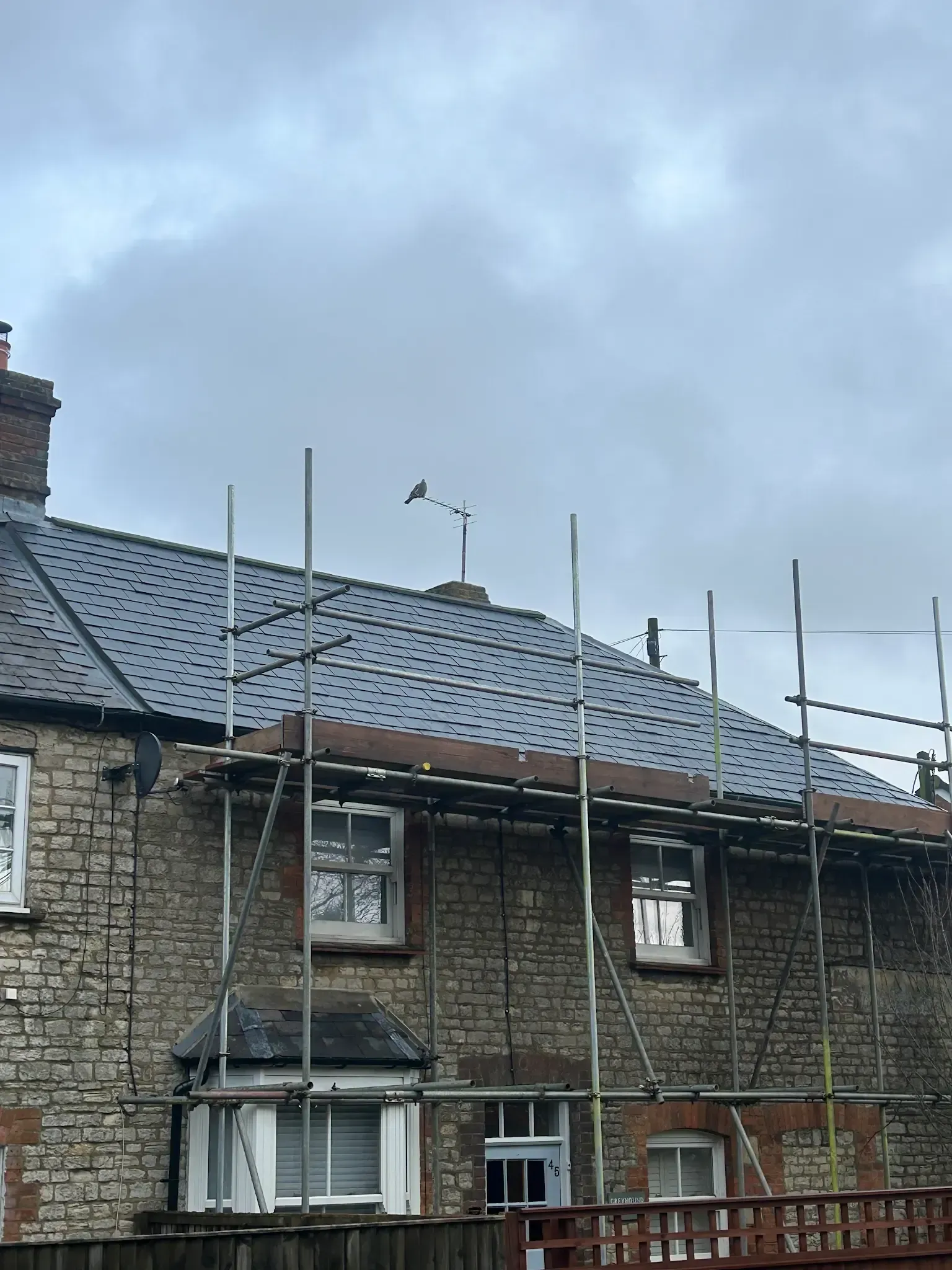 A brick house with scaffolding on the side of it