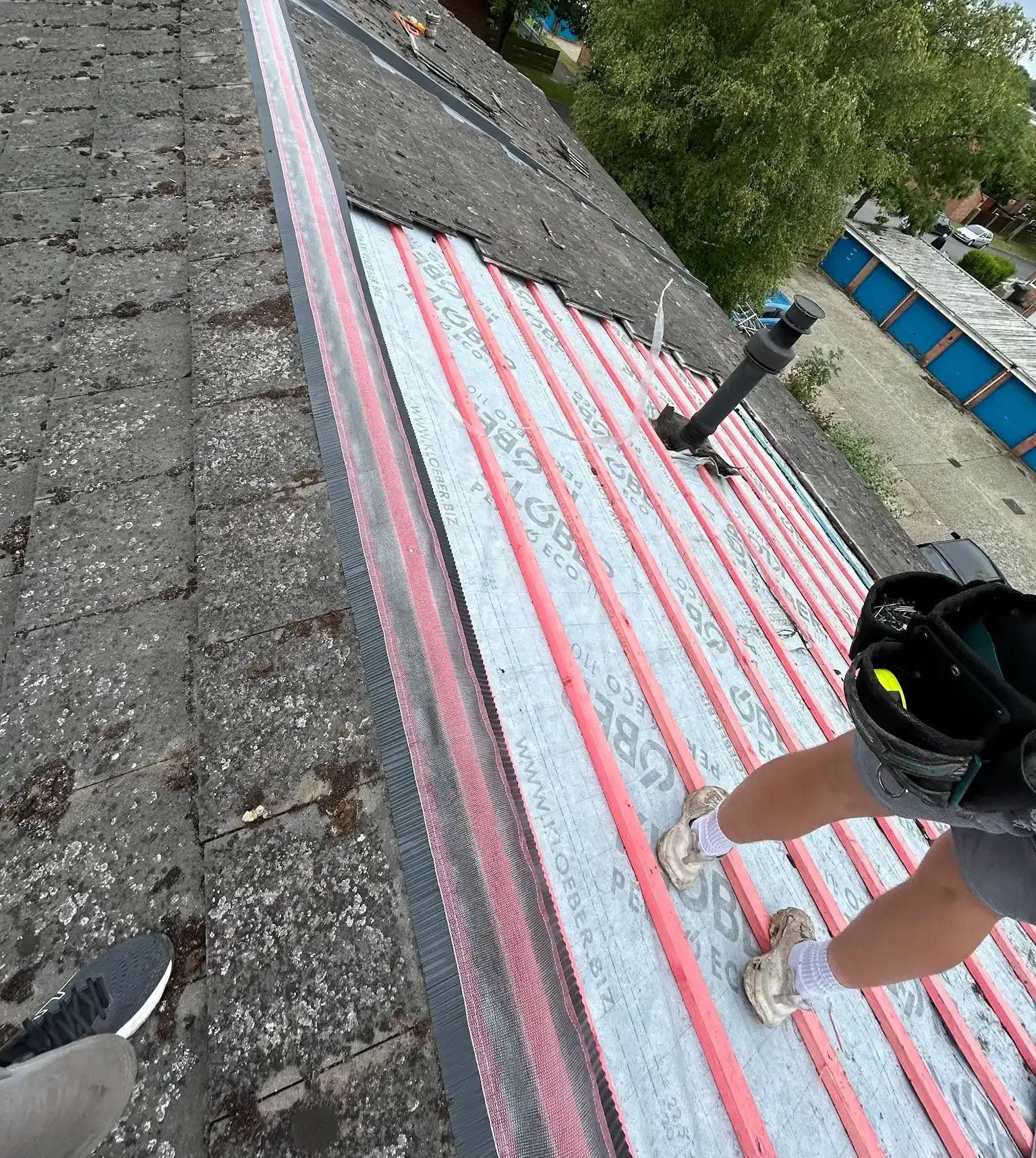 A person is standing on the roof of a building.