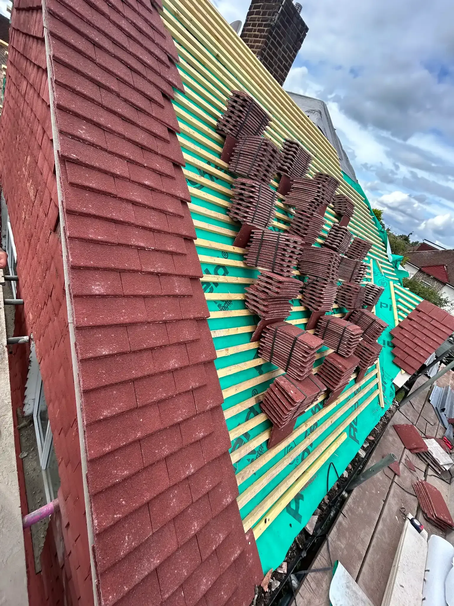 A roof with a lot of tiles on it is being built.