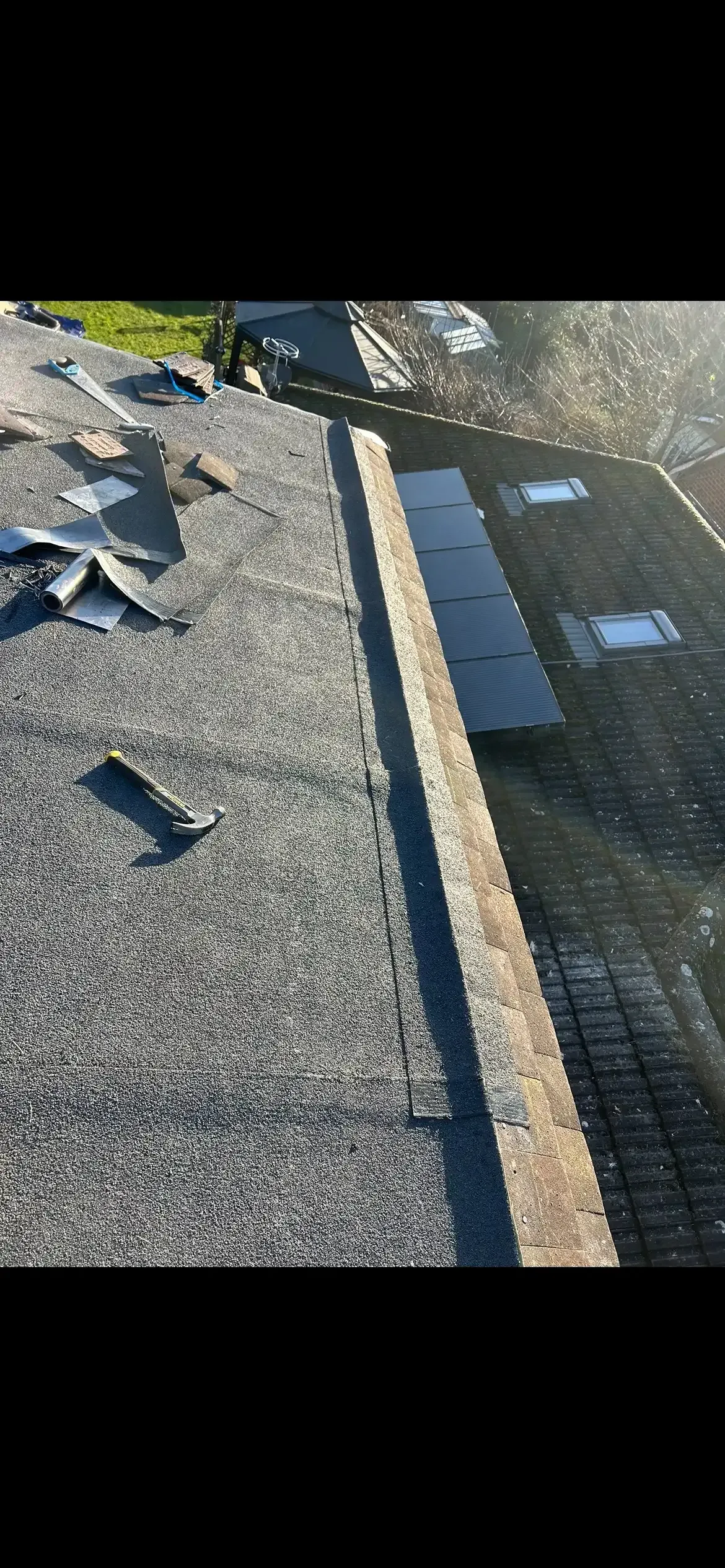 A close up of a roof with a lot of shingles on it.