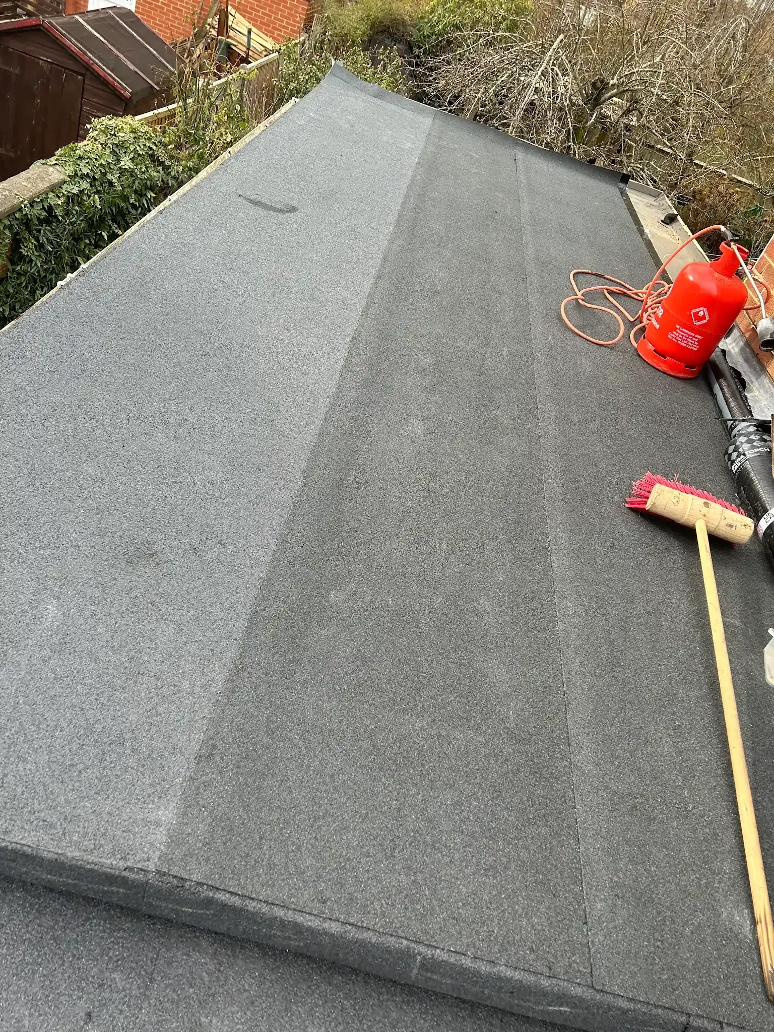 A roof with a broom and a torch on it.