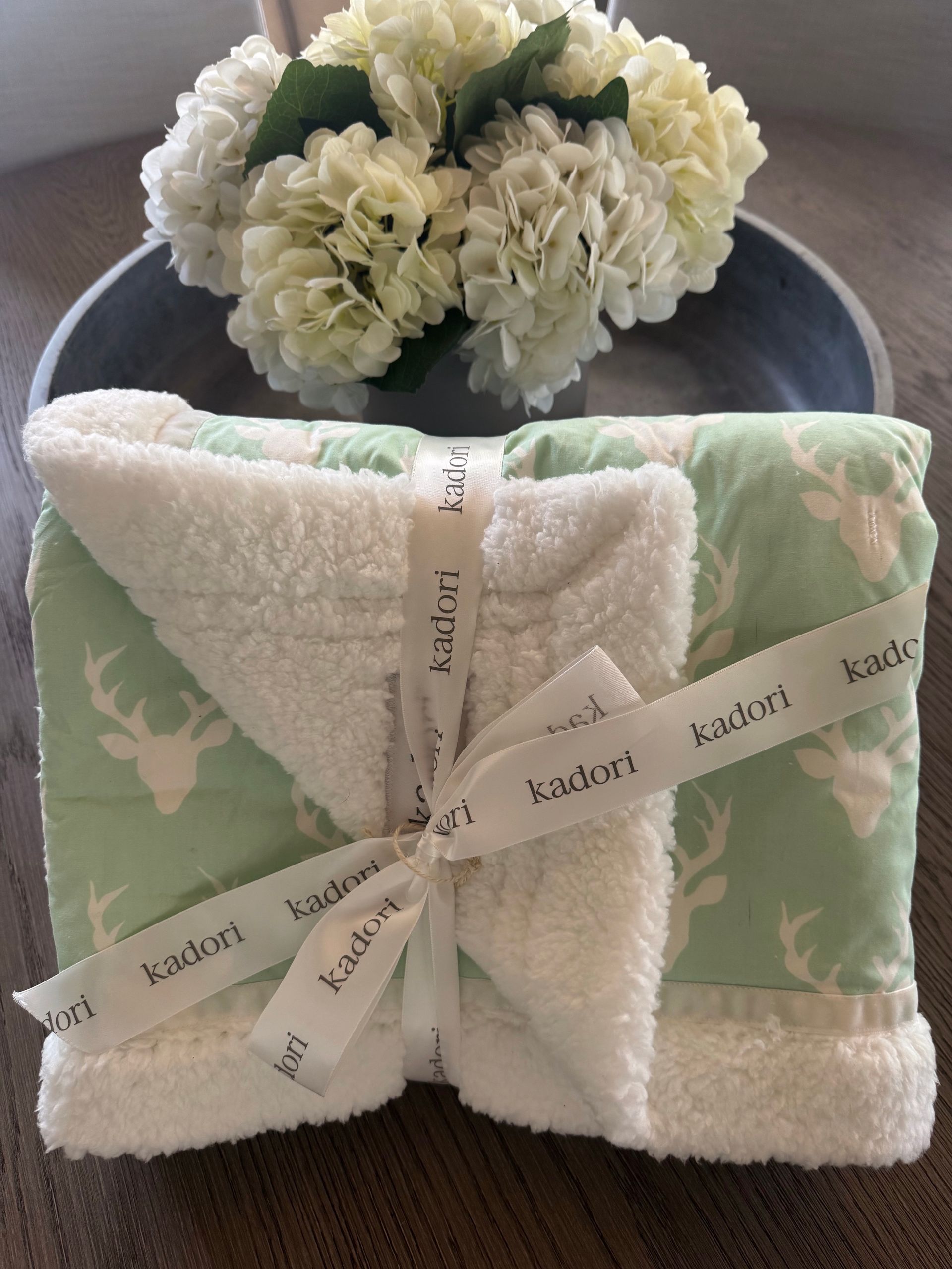 kadori blanket with white antler on mint green background design