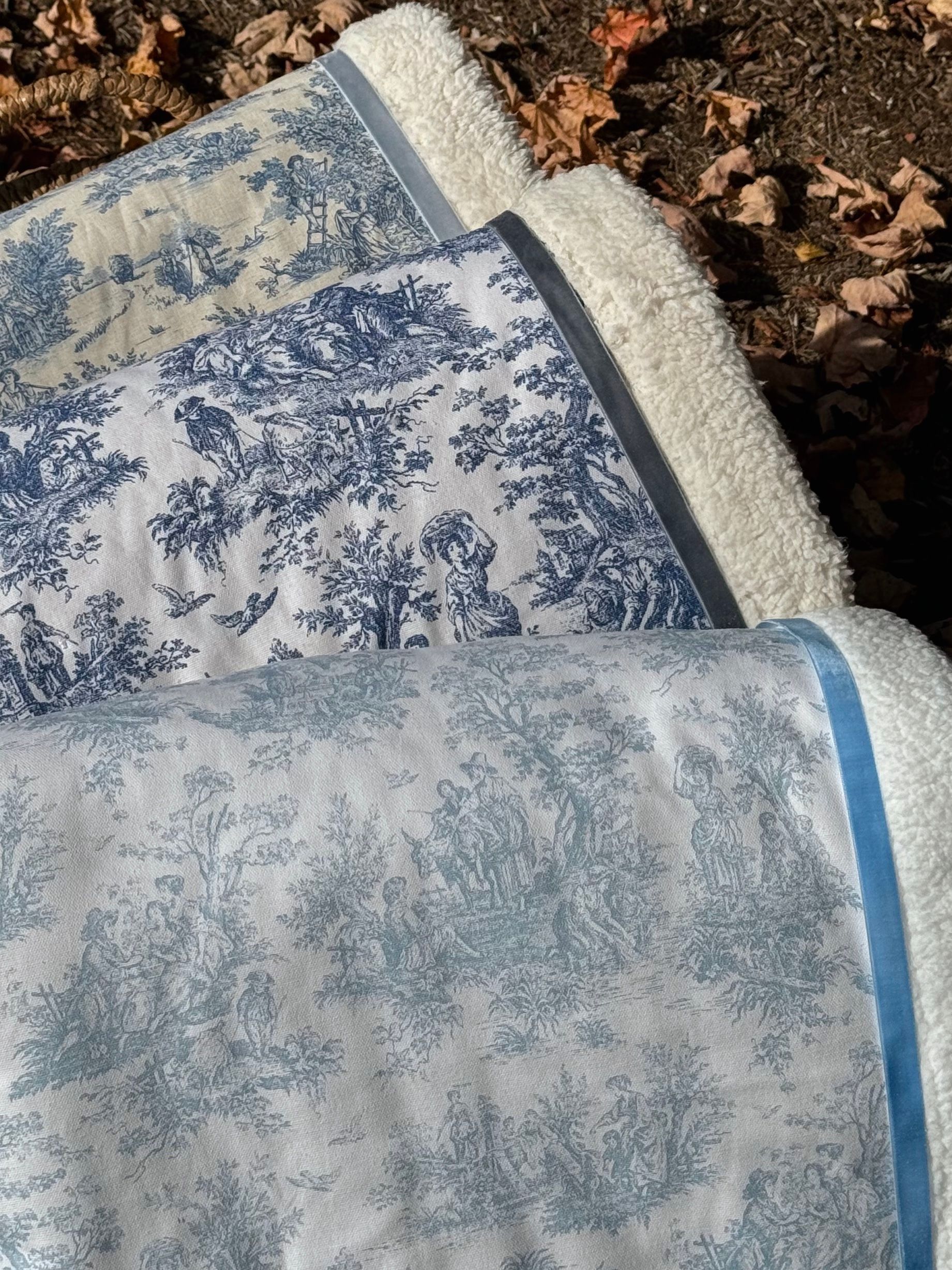 sherpa blankets with printed material that is a blue toile fabric