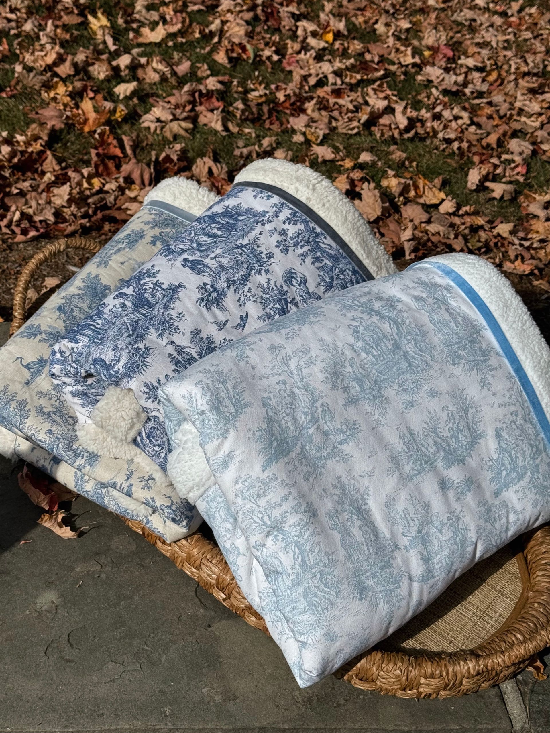sherpa blankets with printed material that is a blue toile fabric