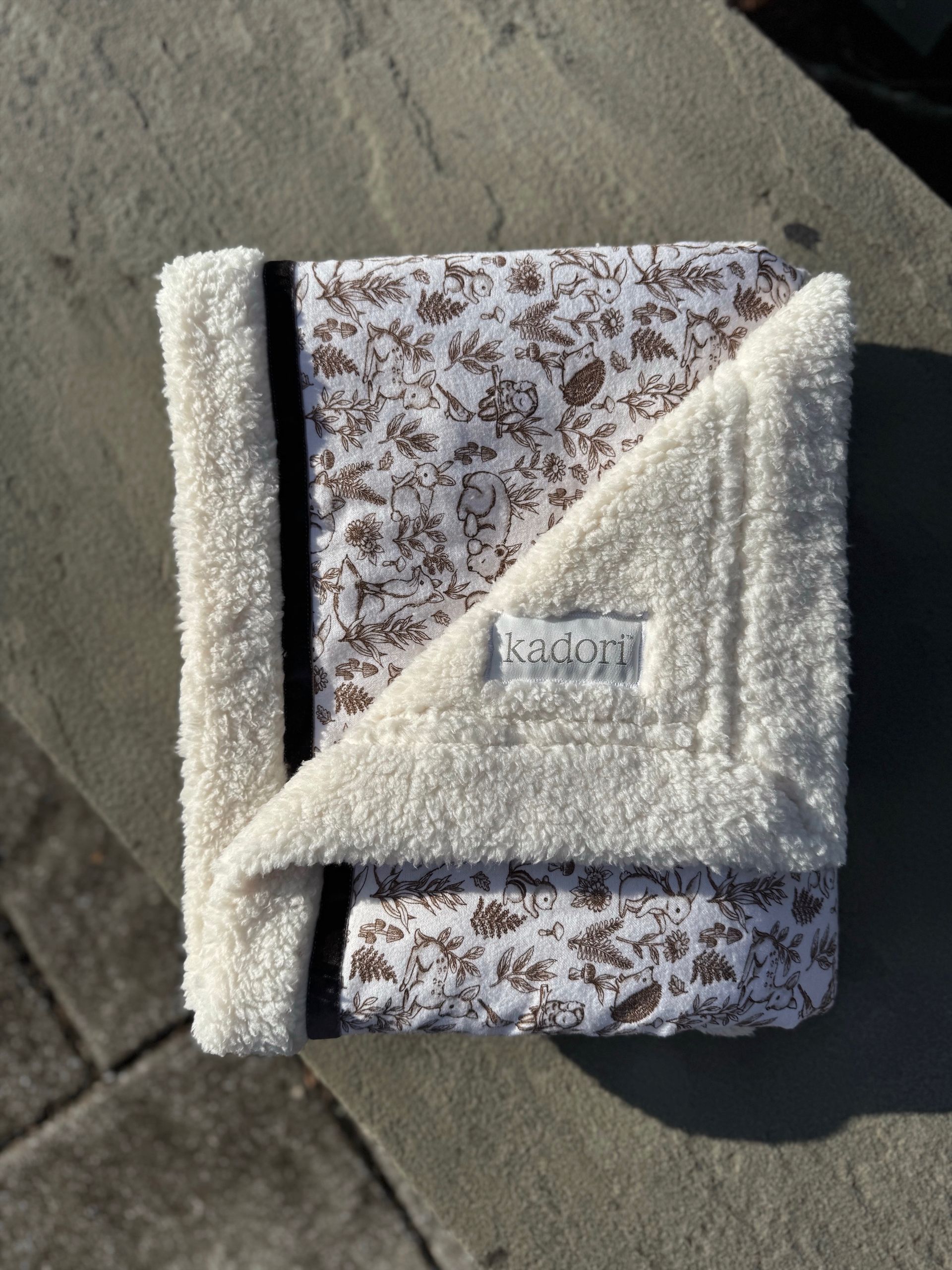 kadori sherpa baby blanket with printed brown forest animal material