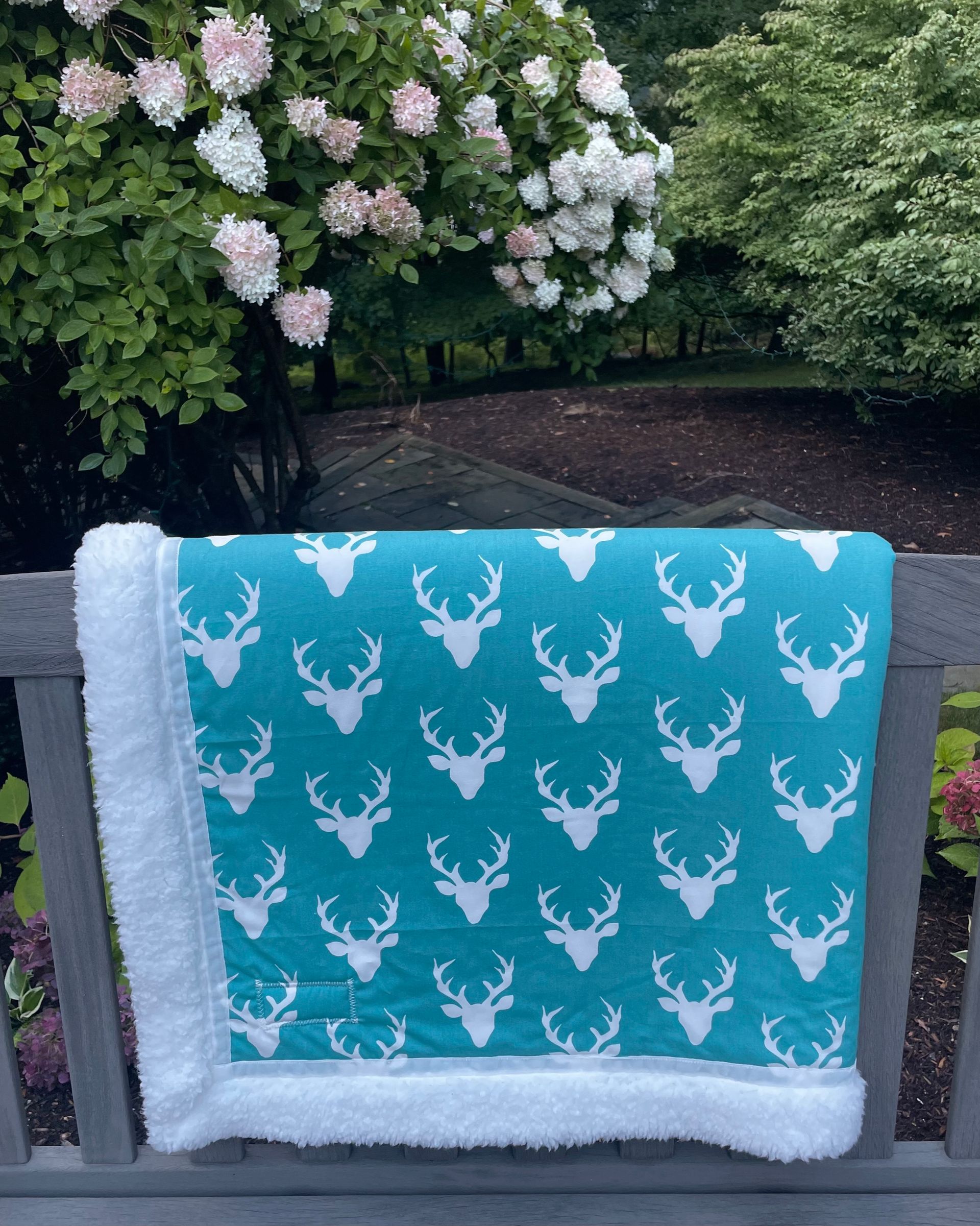 teal background antler fabric blanket
