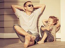 Father And Son Sitting Outside — Financial Services in Wollongong NSW