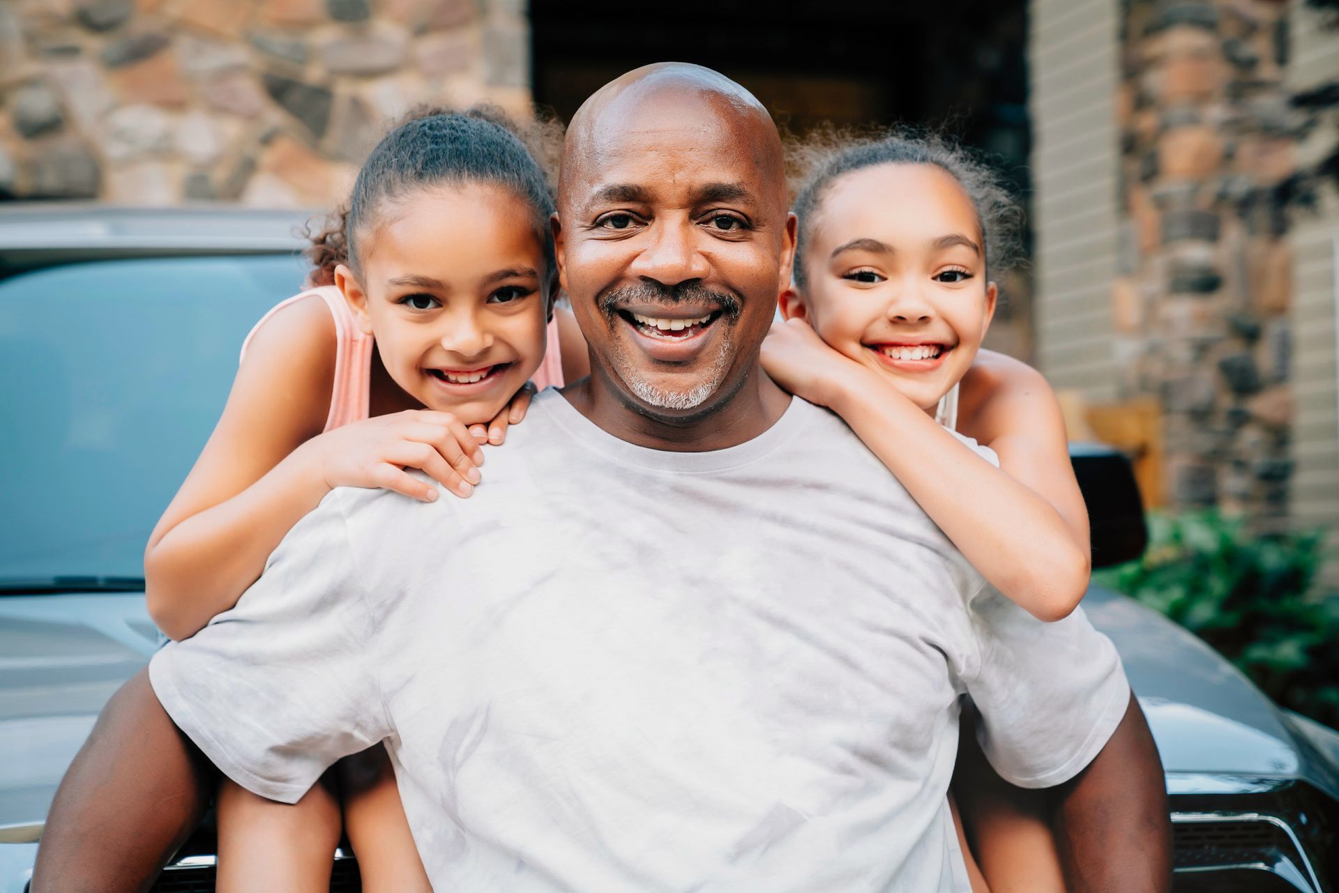A man with a backpack is standing next to a lake in the woods.