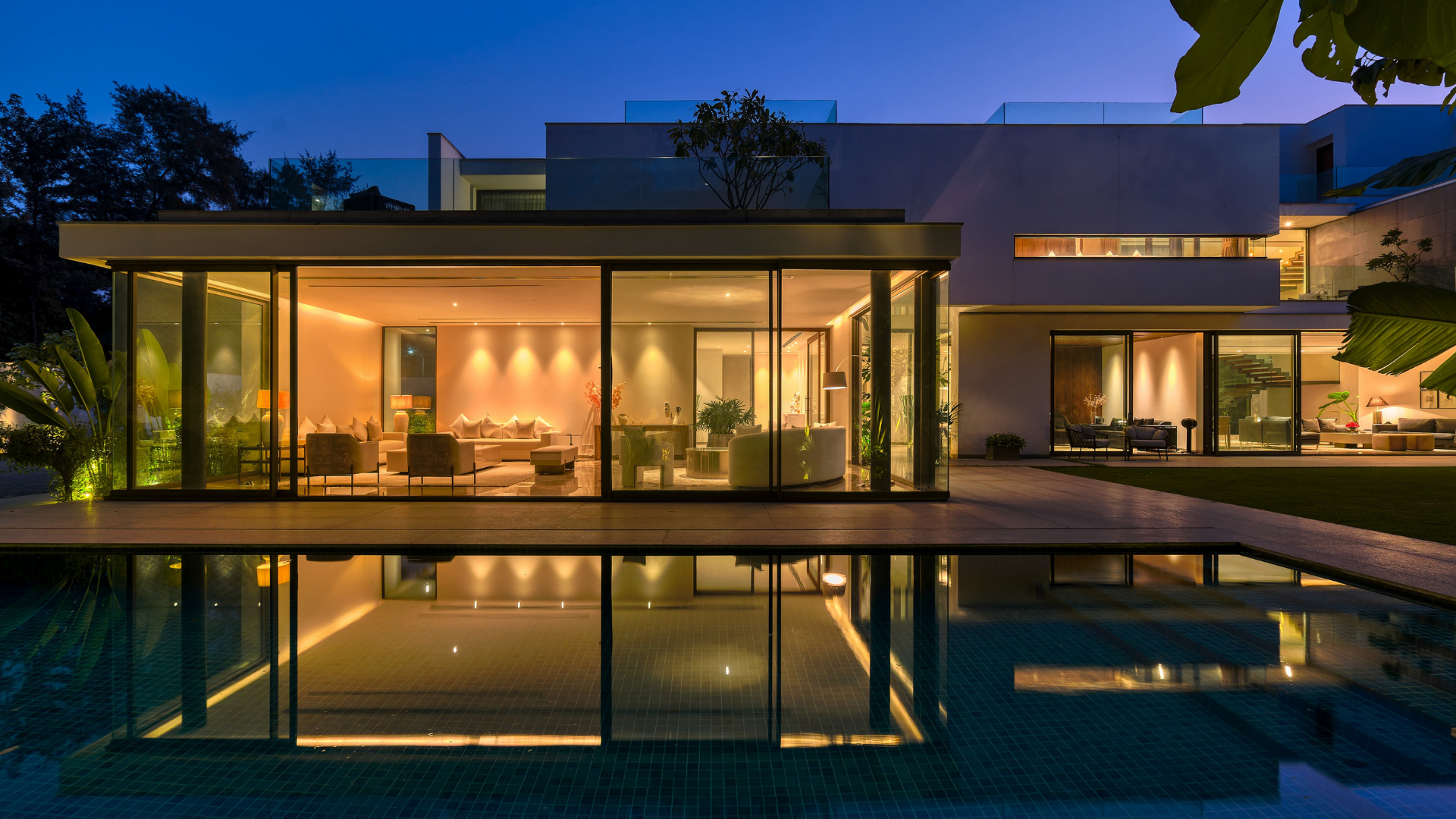A living room with a lot of windows and a view of the desert.