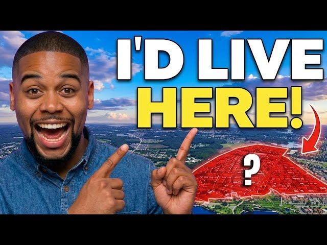 Man smiling and pointing at a red map with “I’D LIVE HERE!” text and a question mark over a cityscape background
