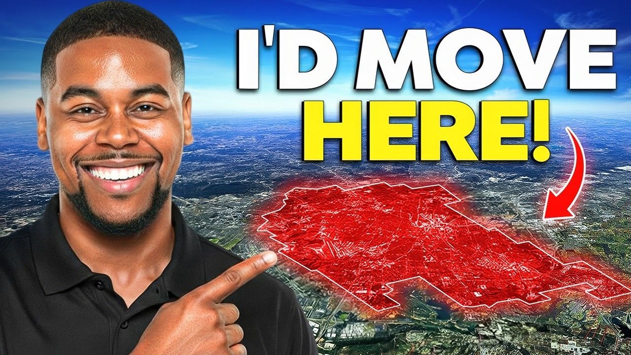 A smiling person points to a red-outlined area on an aerial view of a city with the text