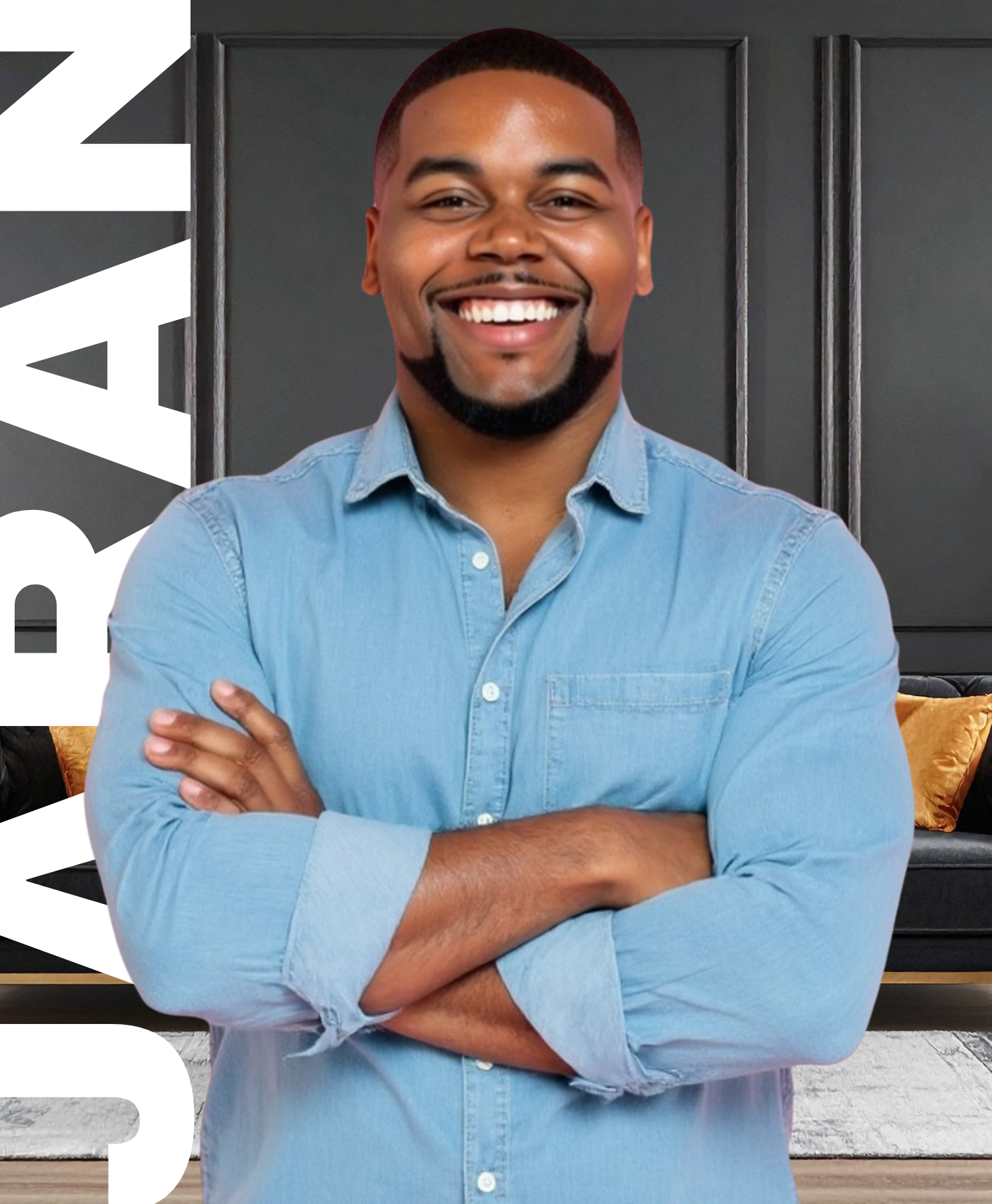 A smiling person with folded arms, wearing a light blue button-down shirt against a dark, paneled wall.